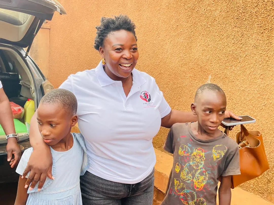 Founder Ritah Namutebi with children during outreach